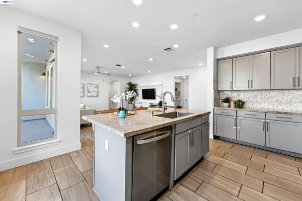 a kitchen with stainless steel appliances granite countertop a sink and cabinets