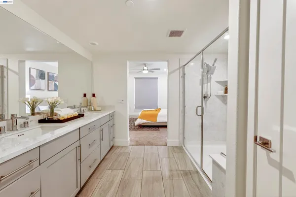 a bathroom with a double vanity sink and mirror