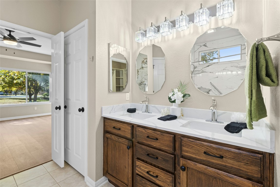 110 Crosby Street Georgetown, TX 78633 - Photo 18 of 40 a bathroom with a double vanity sink and a mirror