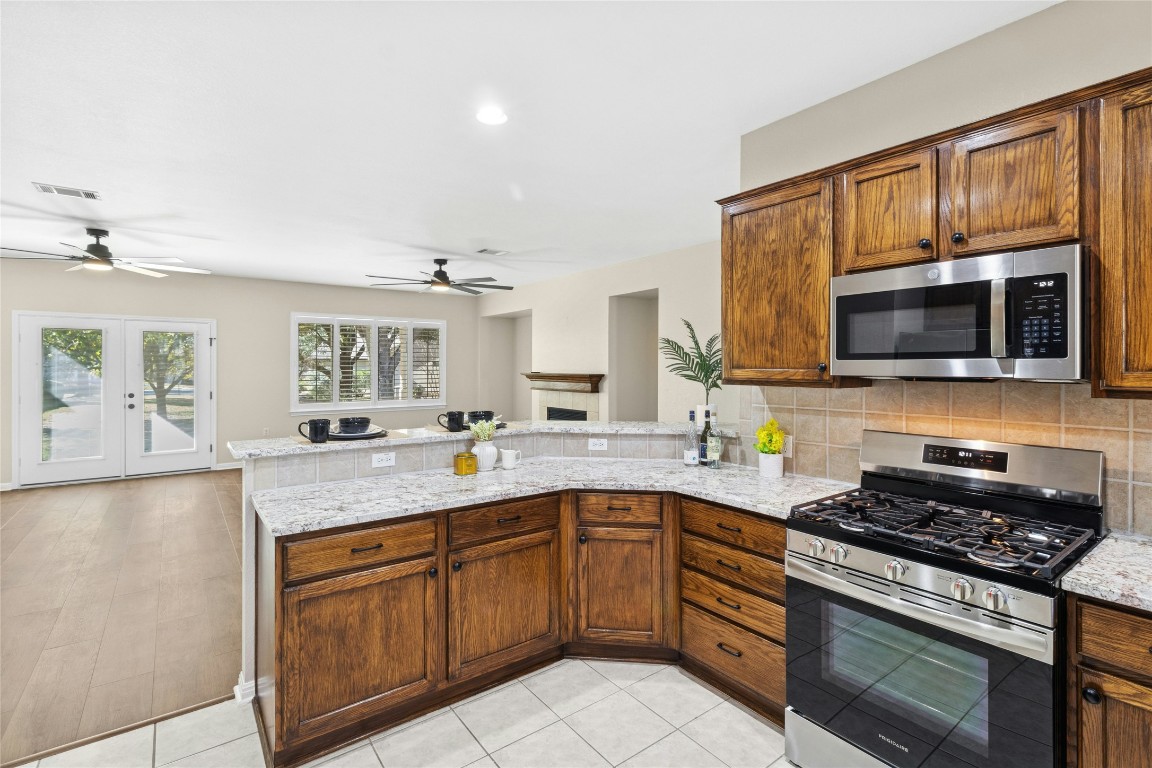 110 Crosby Street Georgetown, TX 78633 - Photo 9 of 40 a kitchen with stainless steel appliances a sink dishwasher stove and microwave