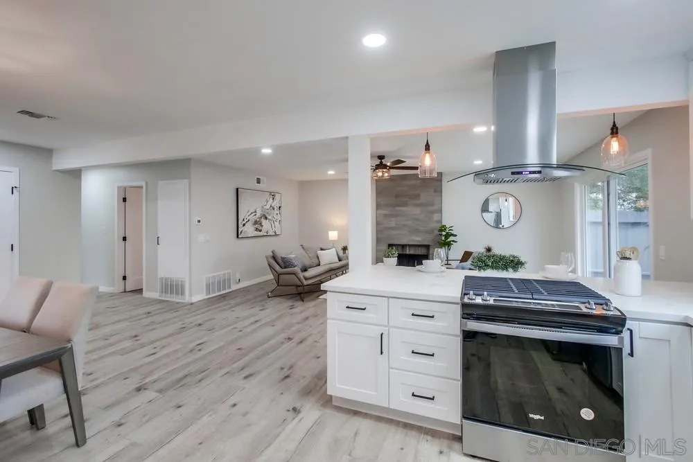 5886 Cowles Mountain Boulevard La Mesa, CA 91942 - Photo 12 of 39 a kitchen with a stove and a wooden floor