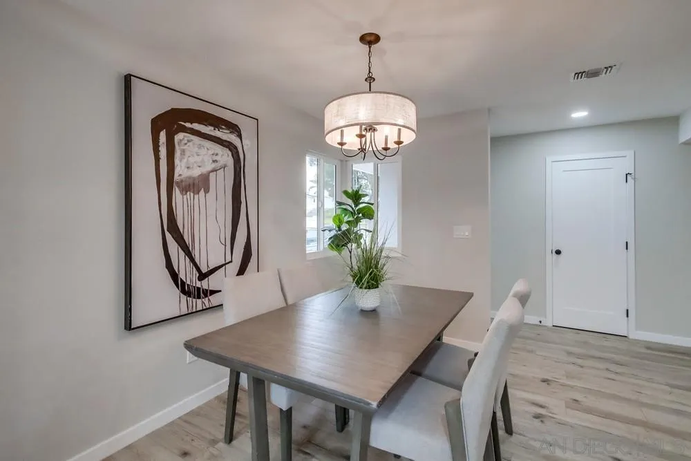 5886 Cowles Mountain Boulevard La Mesa, CA 91942 - Photo 13 of 39 a view of a dining room with furniture wooden floor and chandelier