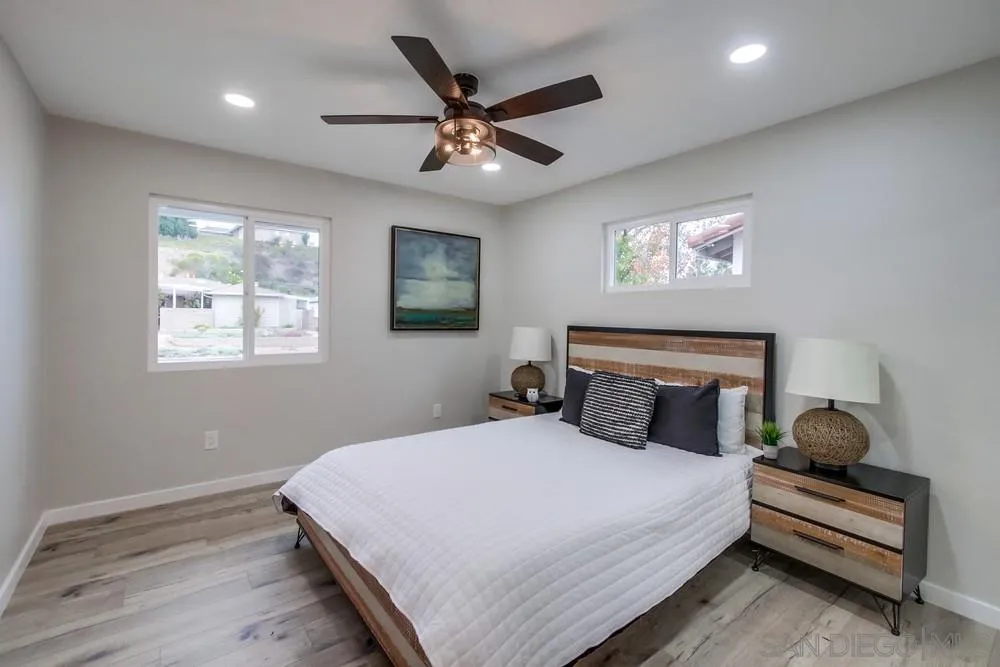 5886 Cowles Mountain Boulevard La Mesa, CA 91942 - Photo 16 of 39 a bedroom with a large bed and a ceiling fan