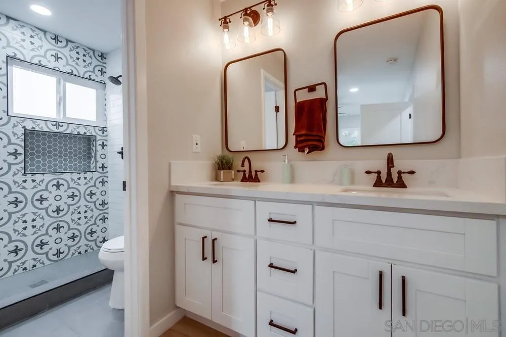 5886 Cowles Mountain Boulevard La Mesa, CA 91942 - Photo 19 of 39 a bathroom with a double vanity sink mirror and double