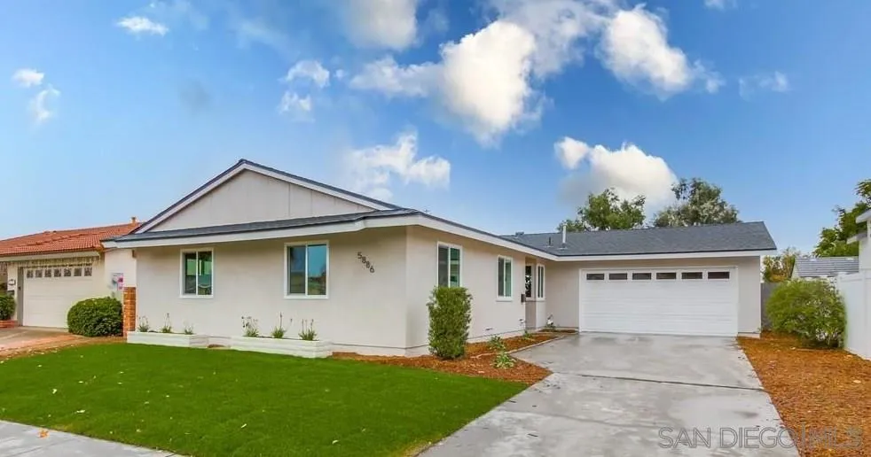 5886 Cowles Mountain Boulevard La Mesa, CA 91942 - Photo 3 of 39 a front view of a house with a yard and garage