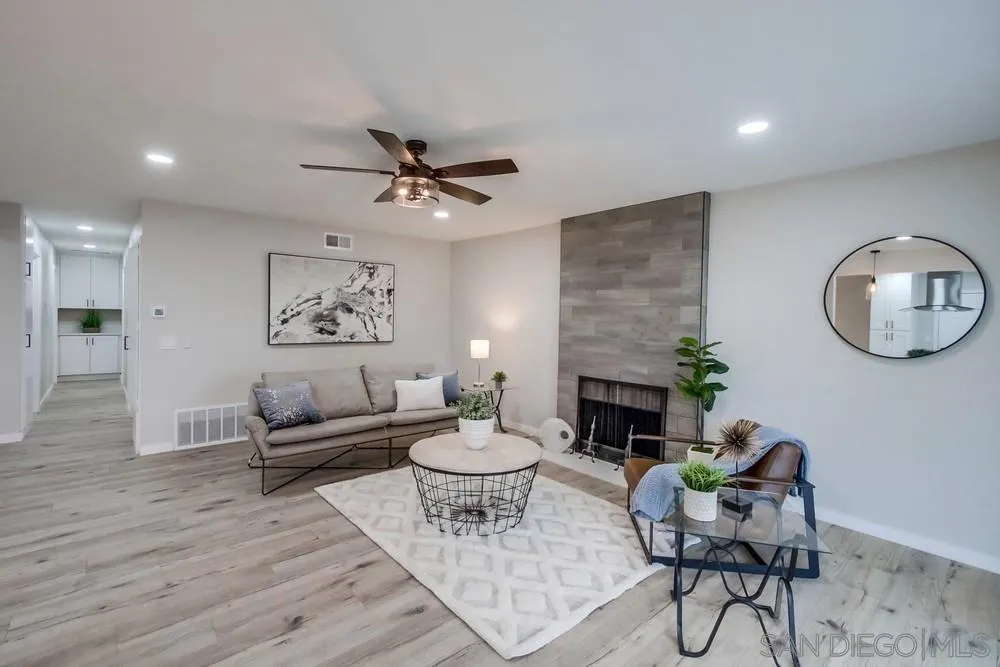 5886 Cowles Mountain Boulevard La Mesa, CA 91942 - Photo 6 of 39 a living room with furniture a fireplace and a potted plant