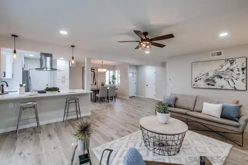 5886 Cowles Mountain Boulevard La Mesa, CA 91942 - Photo 7 of 39 a living room with furniture and a dining table with wooden floor