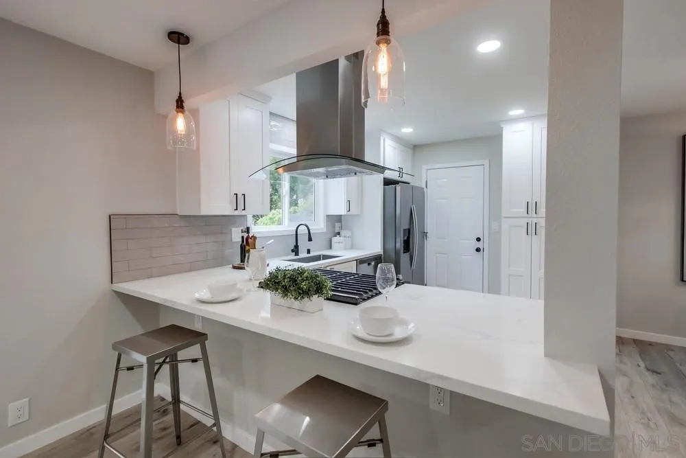 5886 Cowles Mountain Boulevard La Mesa, CA 91942 - Photo 9 of 39 a kitchen with kitchen island a table and chairs in it
