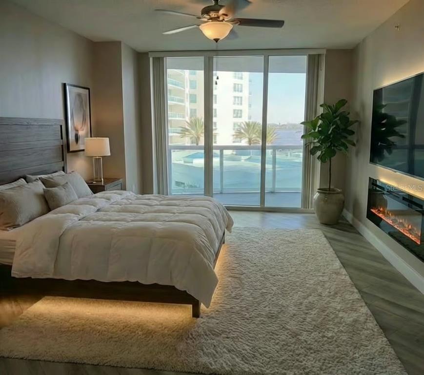 231 Riverside Drive, Unit 3081 Daytona Beach, FL 32117 - Photo 12 of 15 a spacious bedroom with a bed and a flat tv screen on dresser