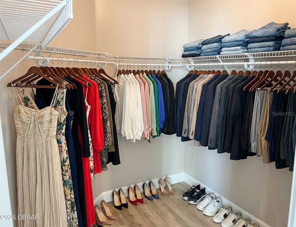 231 Riverside Drive, Unit 3081 Daytona Beach, FL 32117 - Photo 13 of 15 a view of walk in closet with clothes and shoes