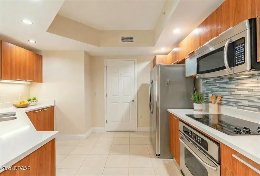 231 Riverside Drive, Unit 3081 Daytona Beach, FL 32117 - Photo 7 of 15 a kitchen with stainless steel appliances granite countertop a sink and a stove