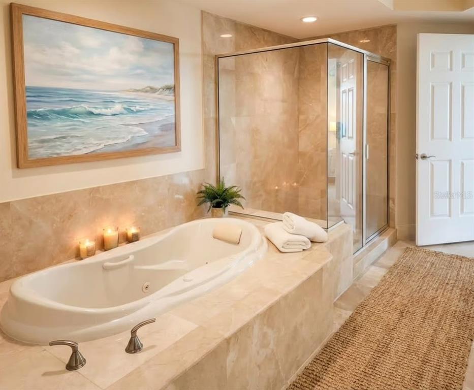 231 Riverside Drive, Unit 3081 Daytona Beach, FL 32117 - Photo 8 of 15 a bathroom with a granite countertop sink and a large mirror