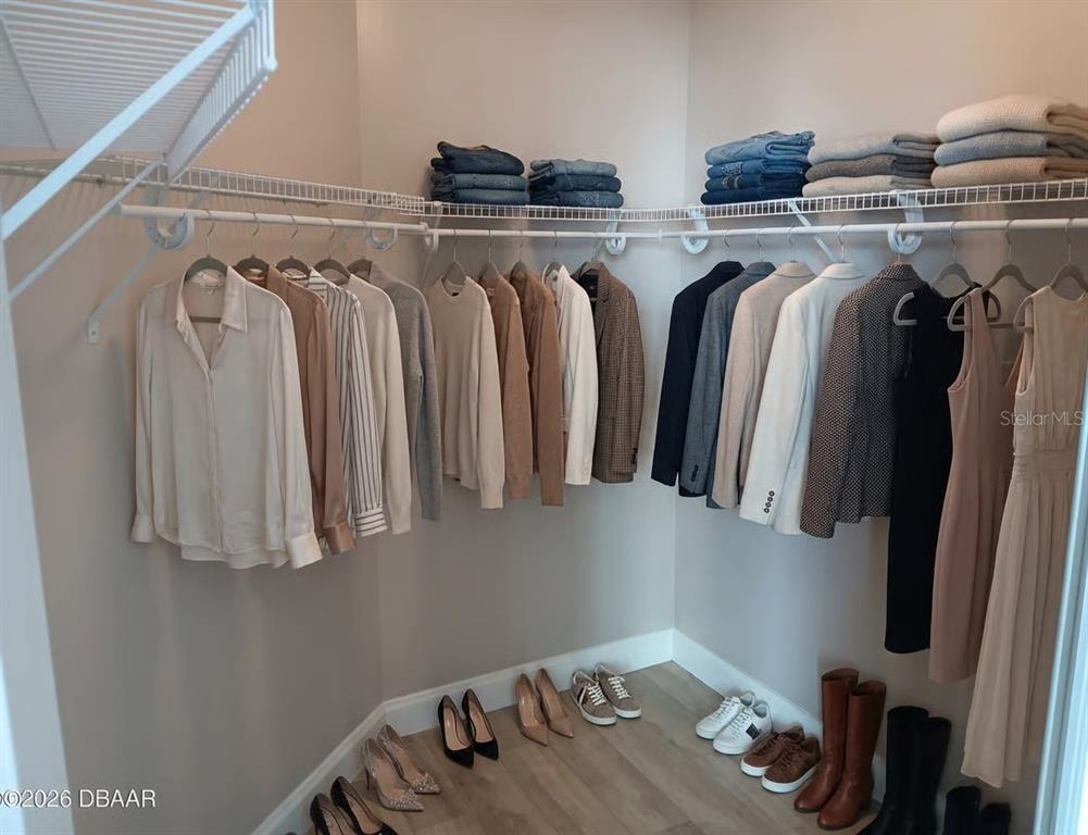 231 Riverside Drive, Unit 3081 Daytona Beach, FL 32117 - Photo 9 of 15 a view of walk in closet with clothes and shoes