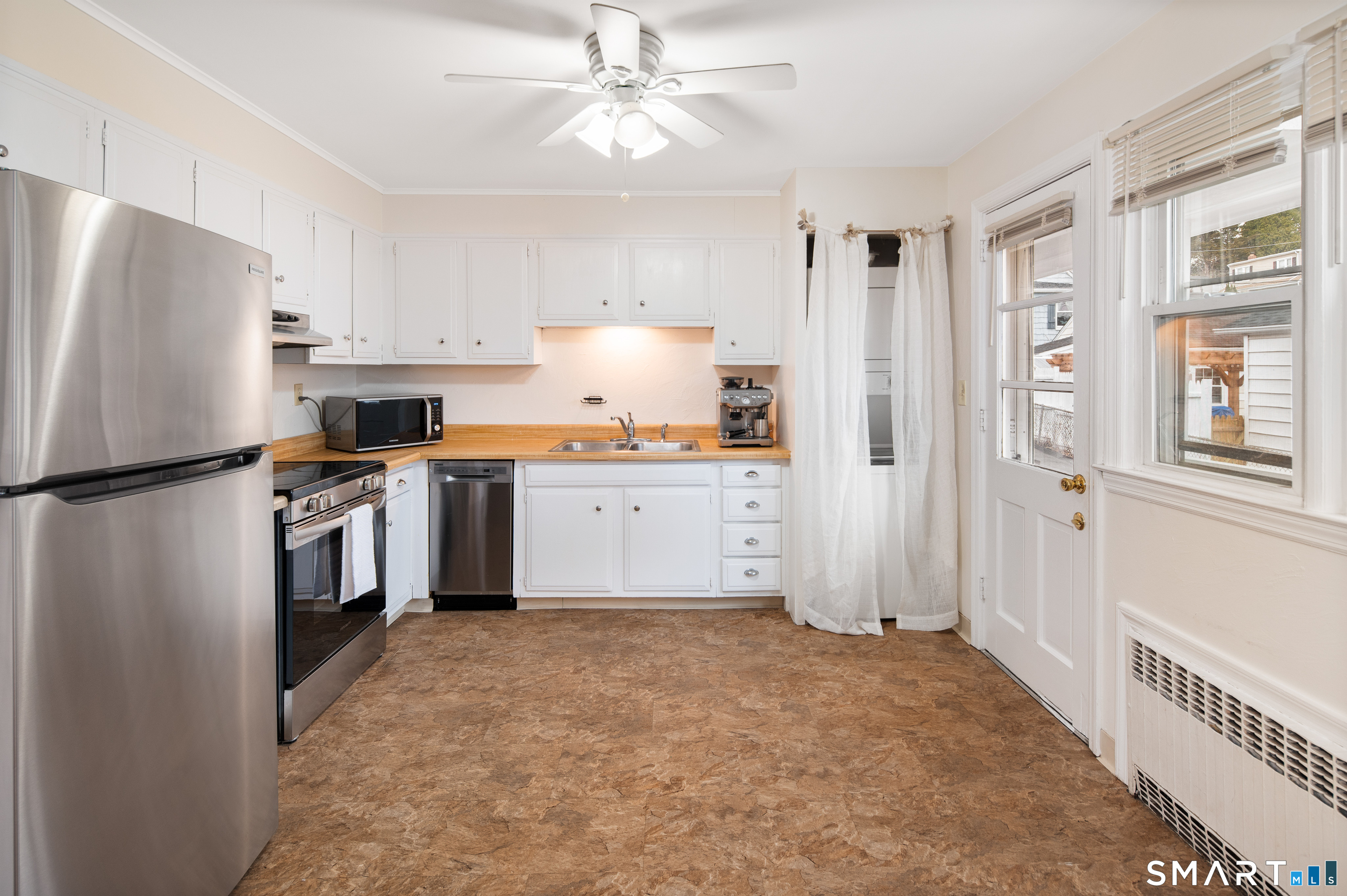 760 Hope Street Stamford, CT 06907 - Photo 15 of 38 a kitchen with stainless steel appliances granite countertop a refrigerator a stove a sink and a refrigerator