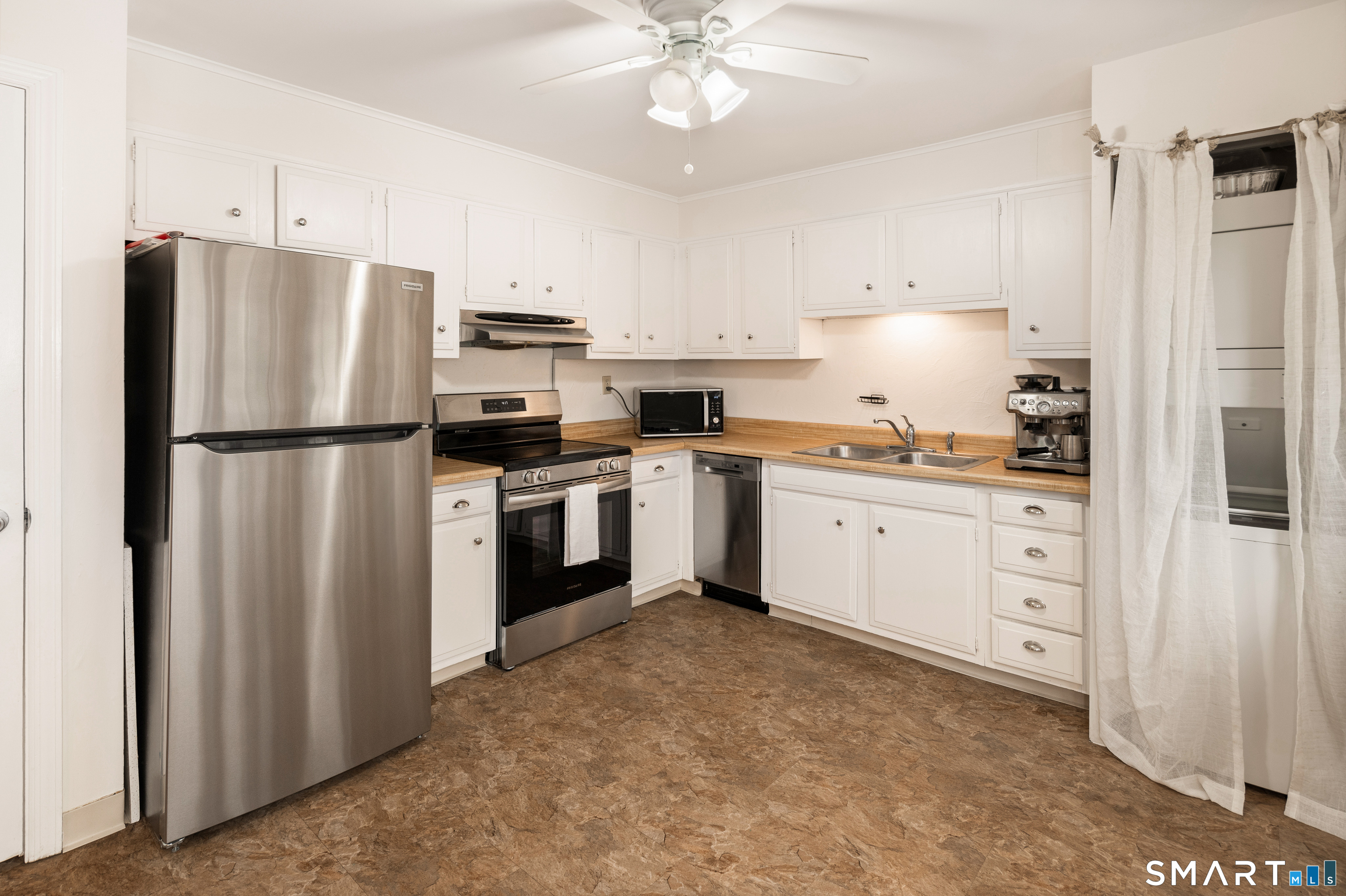 760 Hope Street Stamford, CT 06907 - Photo 16 of 38 a kitchen with white cabinets and white appliances