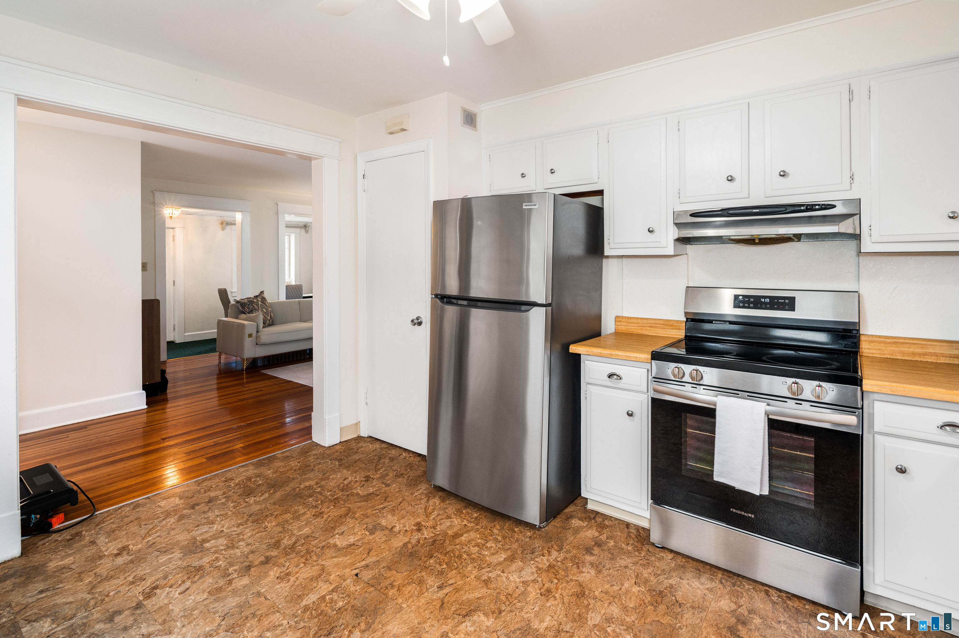 760 Hope Street Stamford, CT 06907 - Photo 17 of 38 a kitchen with a refrigerator stove and white cabinets