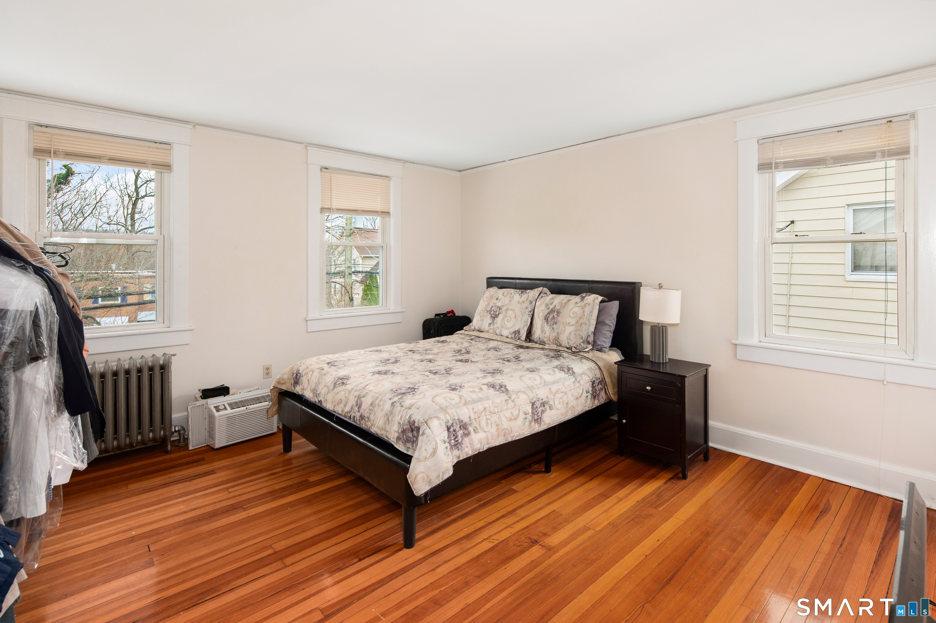 760 Hope Street Stamford, CT 06907 - Photo 18 of 38 a bedroom with a bed and wooden floor