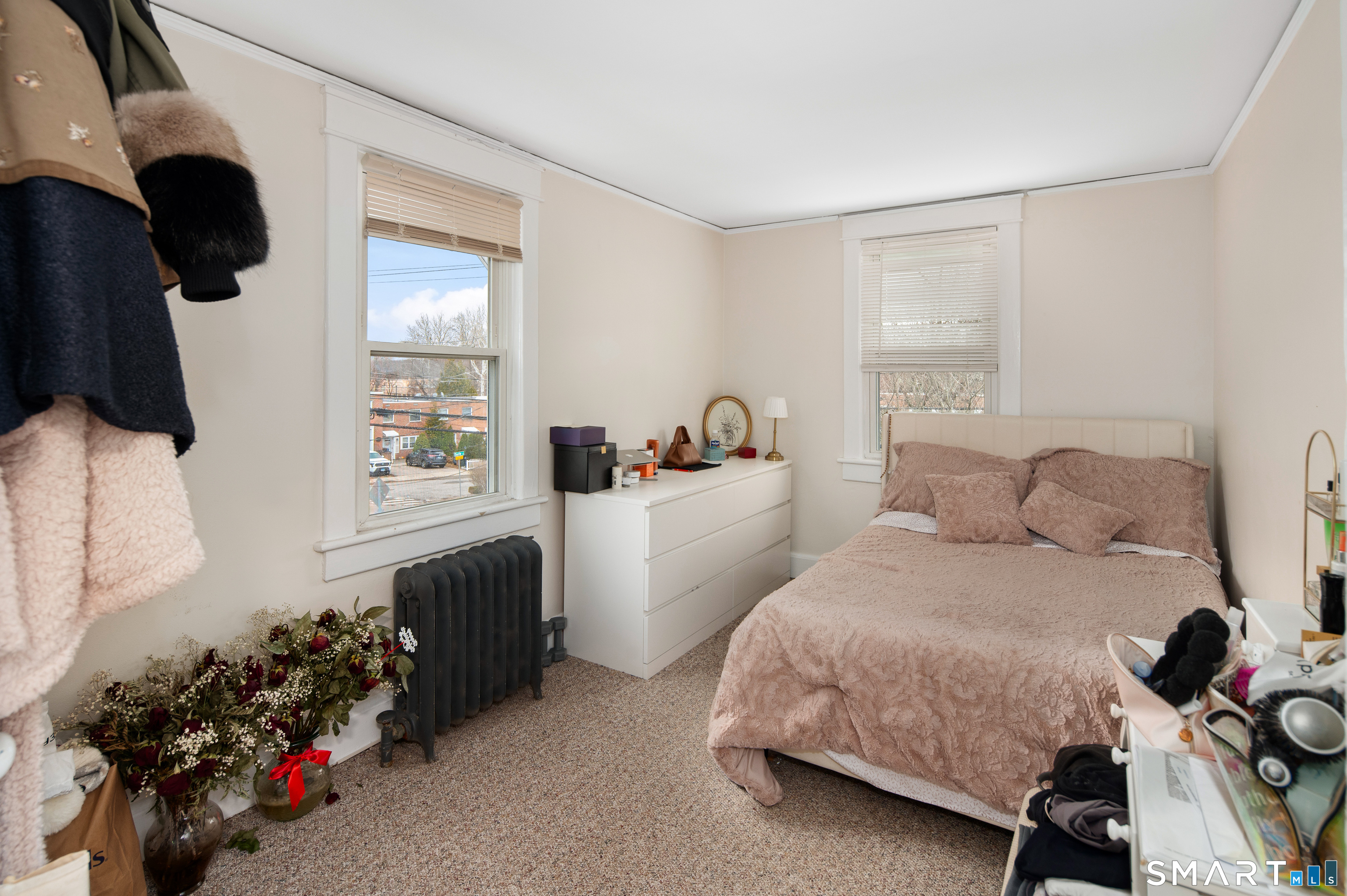 760 Hope Street Stamford, CT 06907 - Photo 19 of 38 a bedroom with a bed and a chandelier