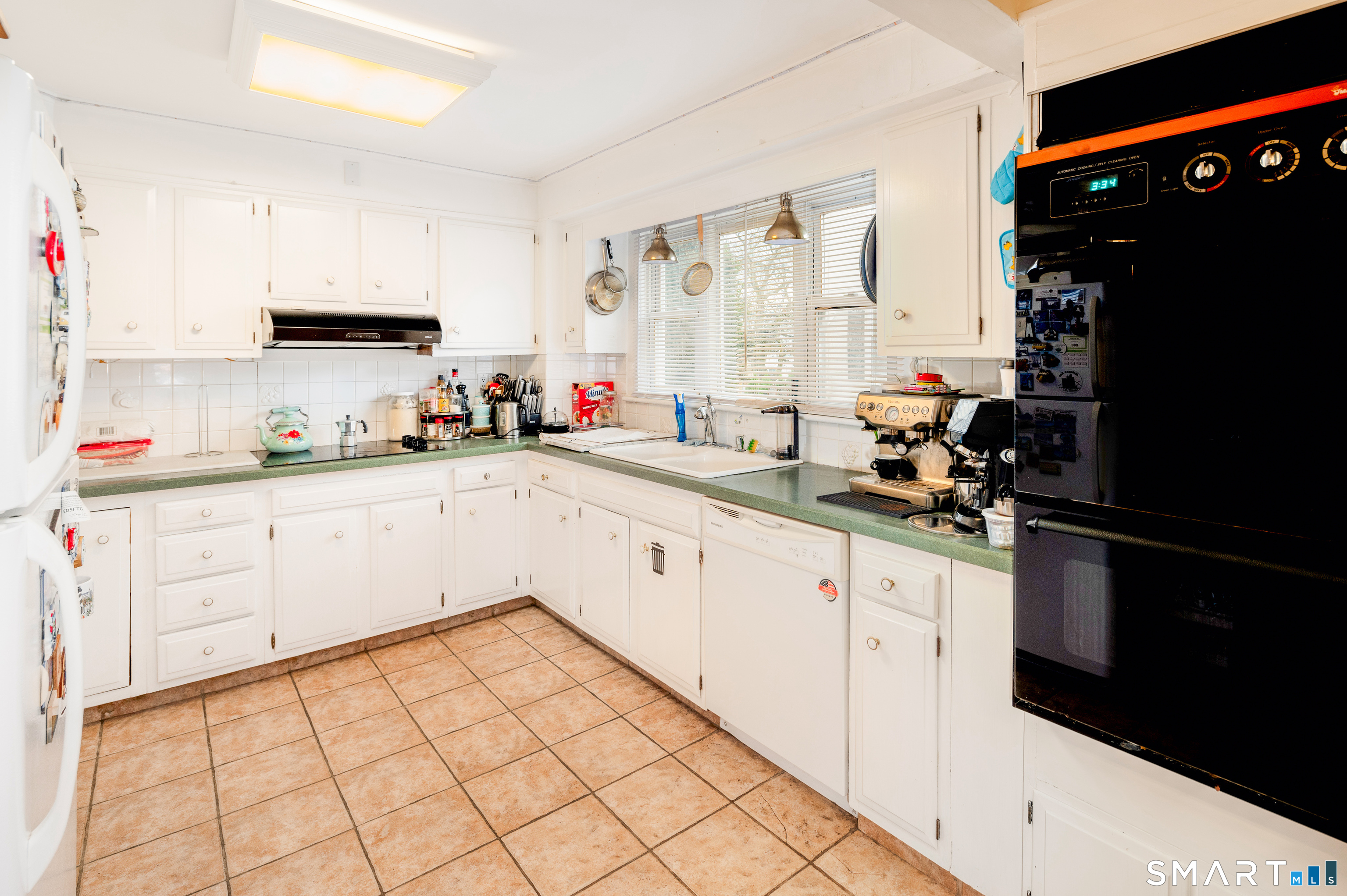 760 Hope Street Stamford, CT 06907 - Photo 24 of 38 a kitchen with a sink dishwasher and white cabinets