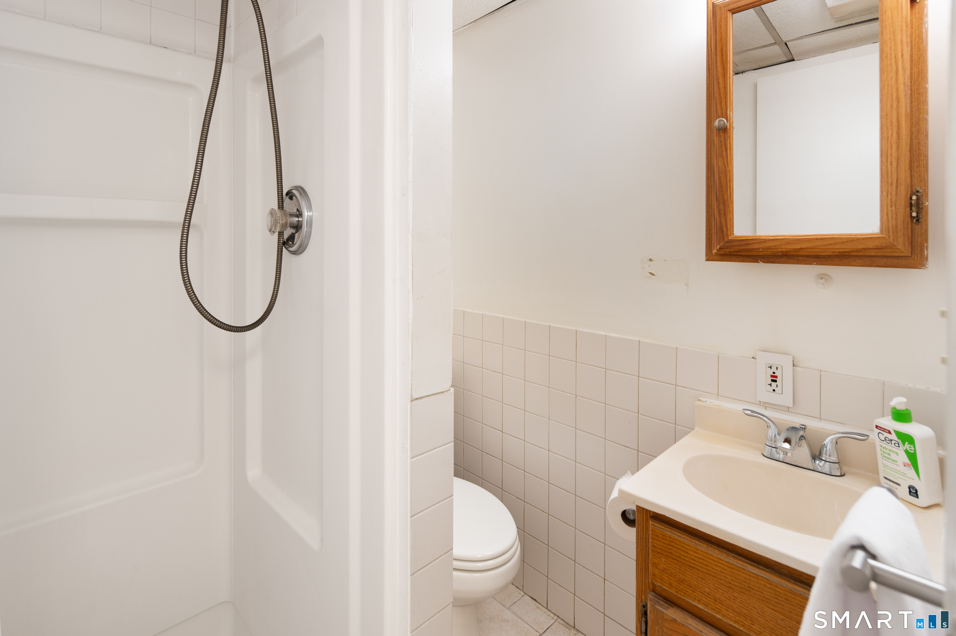 760 Hope Street Stamford, CT 06907 - Photo 32 of 38 a bathroom with a sink toilet and a mirror