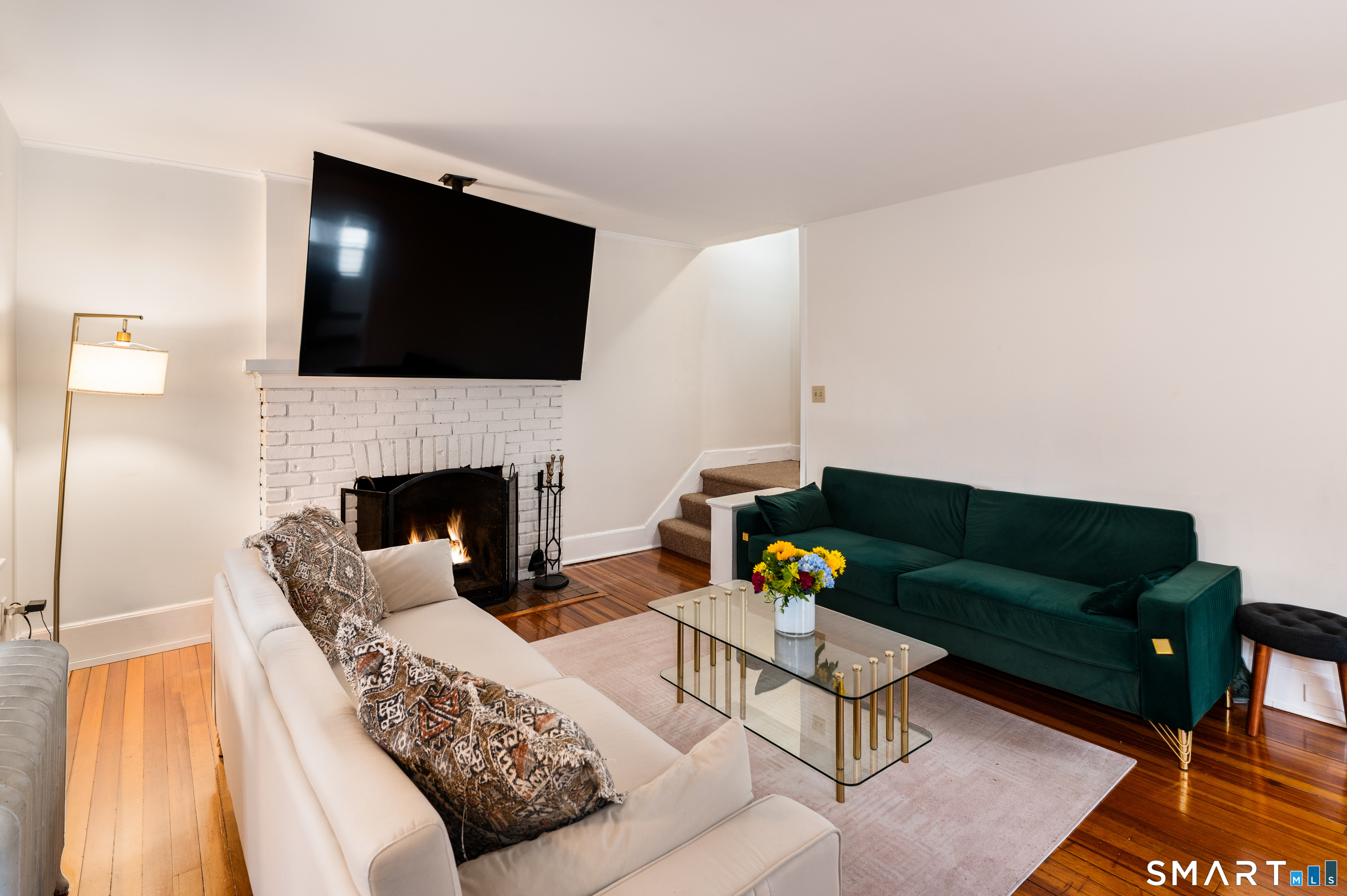 760 Hope Street Stamford, CT 06907 - Photo 8 of 38 a living room with furniture a flat screen tv and a fireplace