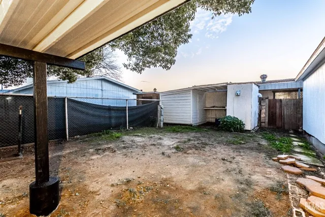 a view of a house with a backyard and garage