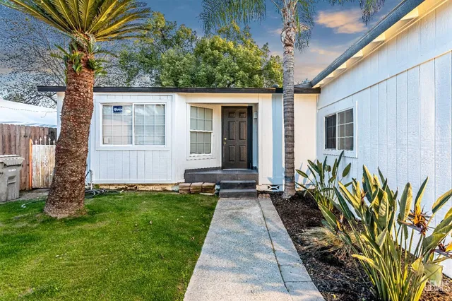 a front view of a house with a garden