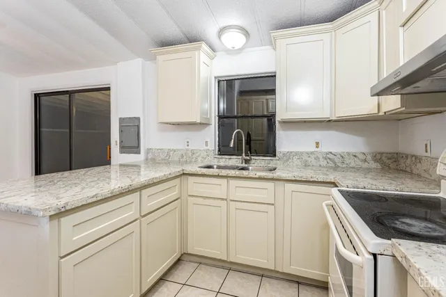 a kitchen with granite countertop a sink and cabinets