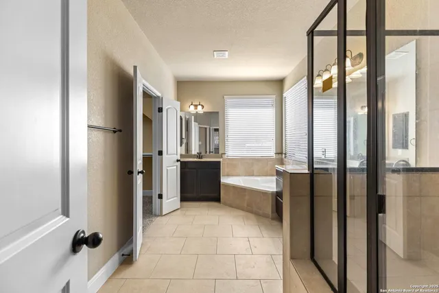 a large bathroom with a tub and shower