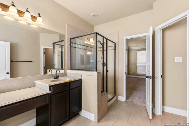 a bathroom with a double vanity sink and mirror