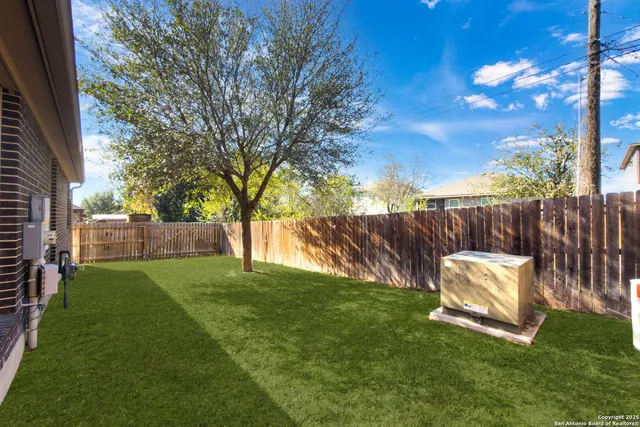 a backyard of a house with table and chairs