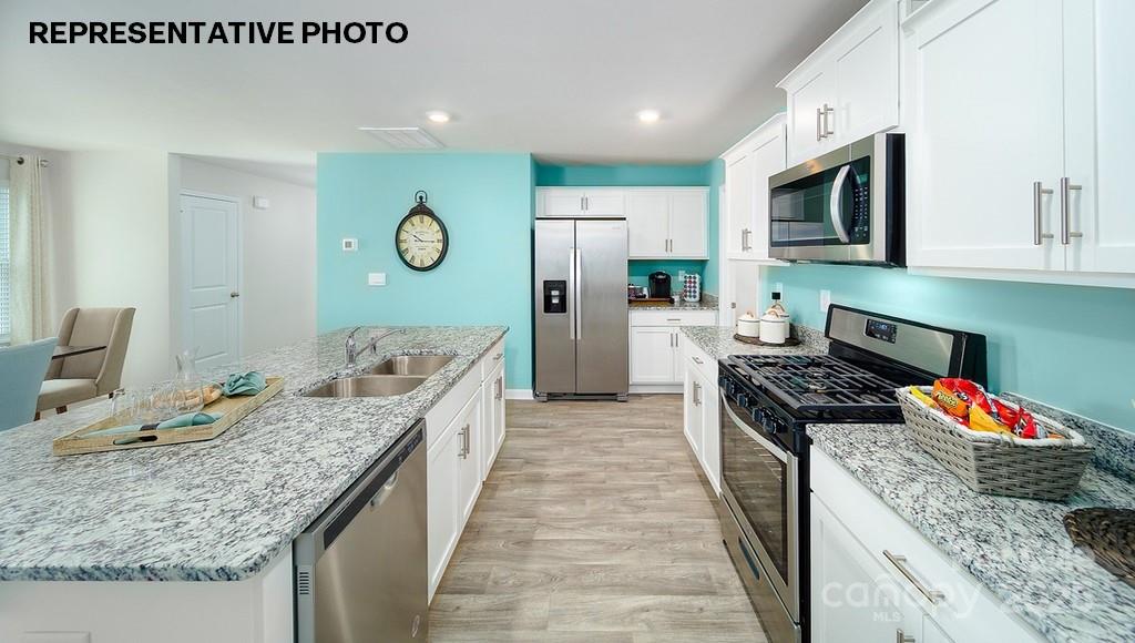 834 North Naughton Street Chester, SC 29706 - Photo 6 of 28 a kitchen with a stove top oven a sink and a refrigerator
