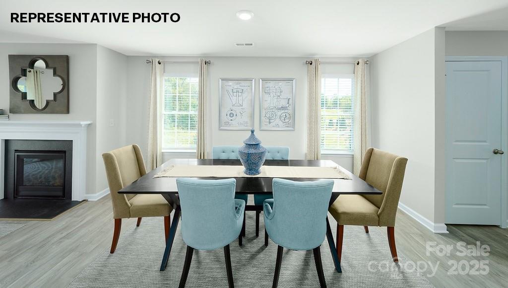834 North Naughton Street Chester, SC 29706 - Photo 9 of 28 a dining room with furniture a chandelier and wooden floor