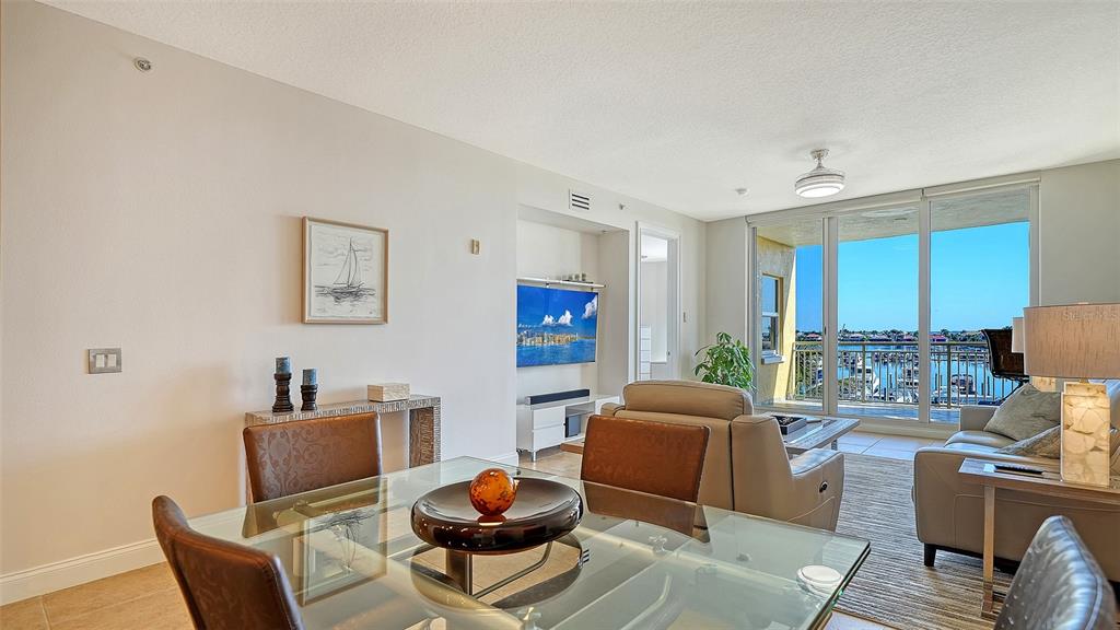610 Riviera Dunes Way, Unit 306 Palmetto, FL 34221 - Photo 18 of 58 a living room with furniture and a wooden floor