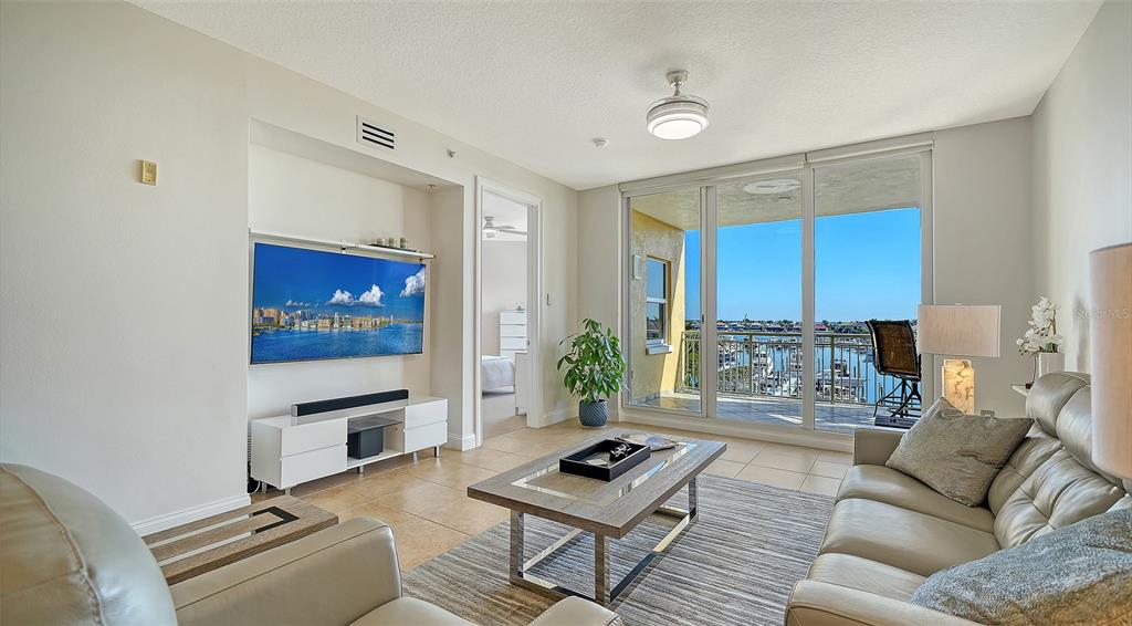 610 Riviera Dunes Way, Unit 306 Palmetto, FL 34221 - Photo 19 of 58 a living room with furniture and a flat screen tv