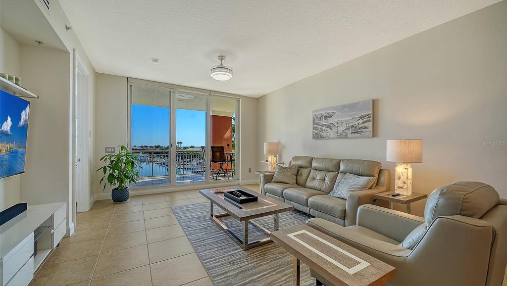 610 Riviera Dunes Way, Unit 306 Palmetto, FL 34221 - Photo 20 of 58 a living room with furniture and a potted plant