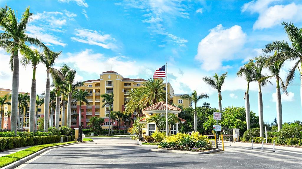 610 Riviera Dunes Way, Unit 306 Palmetto, FL 34221 - Photo 2 of 58 a view of a multi story residential apartment building with a palm tree