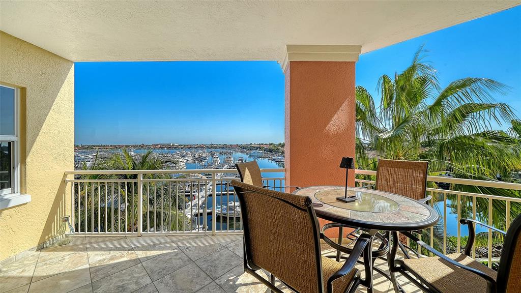 610 Riviera Dunes Way, Unit 306 Palmetto, FL 34221 - Photo 27 of 58 a balcony with table and chairs