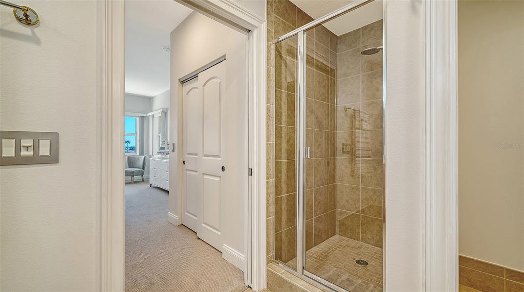 610 Riviera Dunes Way, Unit 306 Palmetto, FL 34221 - Photo 34 of 58 a bathroom with a shower and a glass door