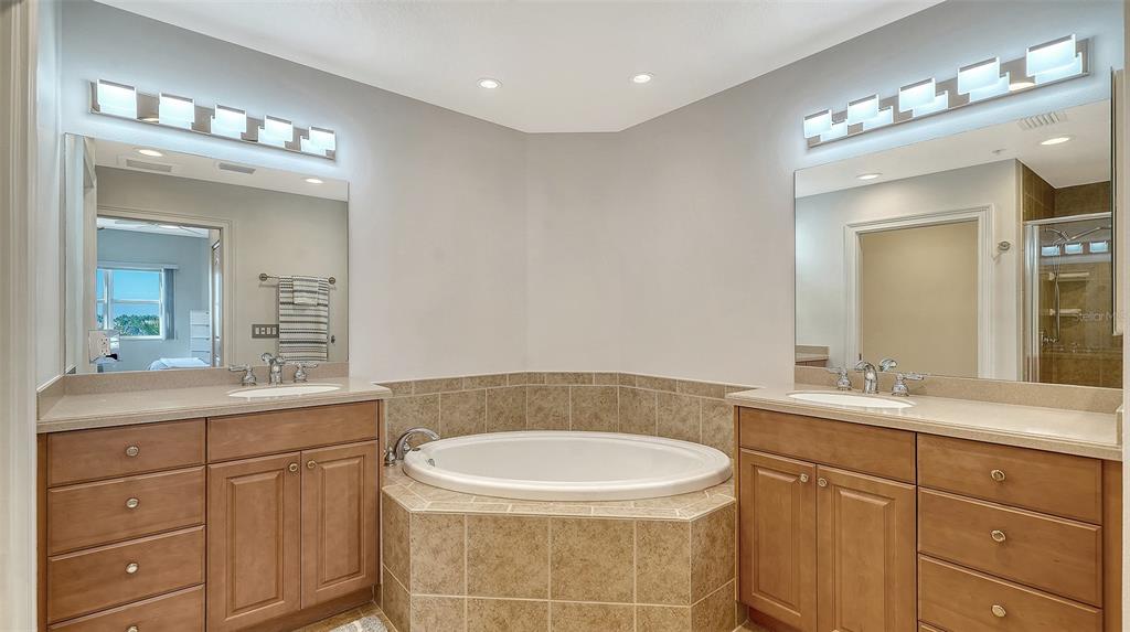 610 Riviera Dunes Way, Unit 306 Palmetto, FL 34221 - Photo 35 of 58 a bathroom with a sink and a mirror