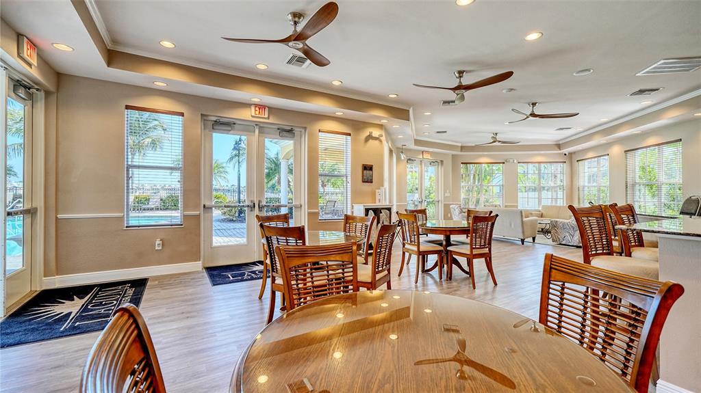 610 Riviera Dunes Way, Unit 306 Palmetto, FL 34221 - Photo 49 of 58 a living room with lots of furniture and a large window