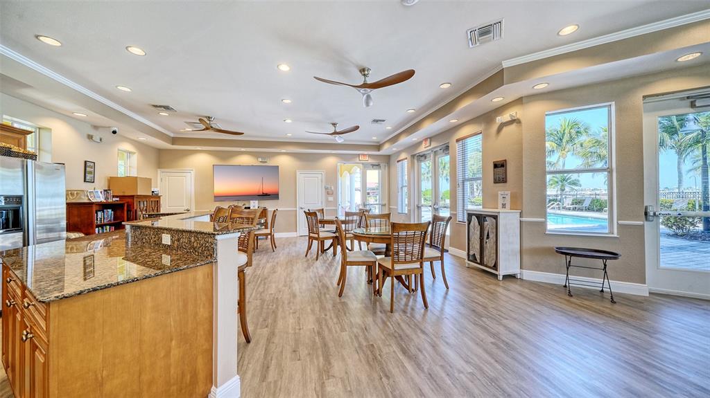 610 Riviera Dunes Way, Unit 306 Palmetto, FL 34221 - Photo 51 of 58 a dining room with furniture window wooden floor