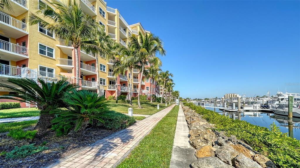 610 Riviera Dunes Way, Unit 306 Palmetto, FL 34221 - Photo 55 of 58 a view of a tall building with a yard