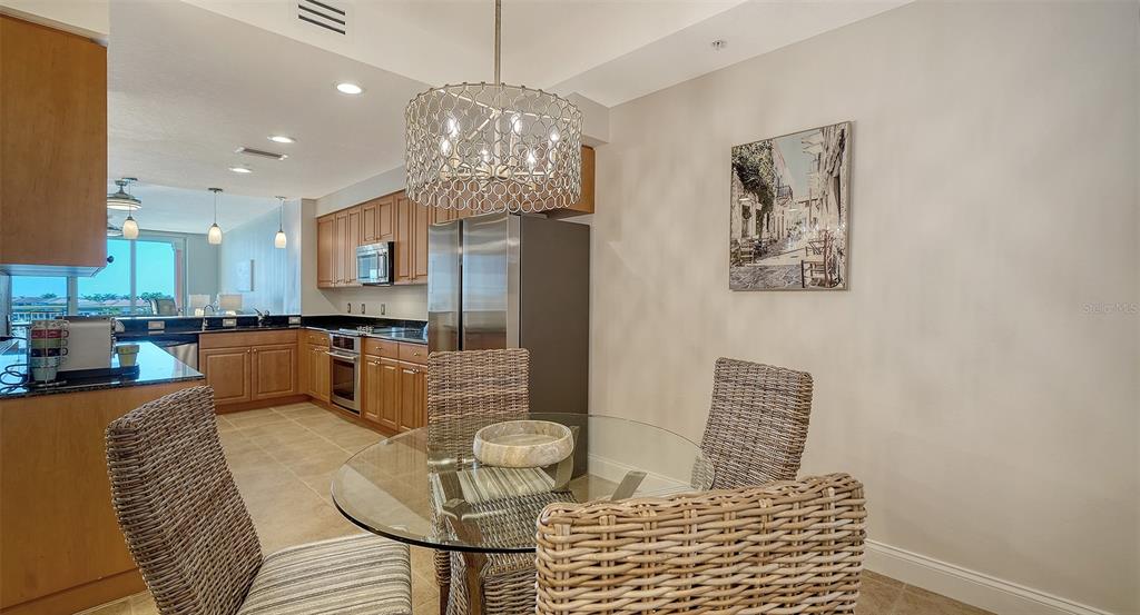 610 Riviera Dunes Way, Unit 306 Palmetto, FL 34221 - Photo 8 of 58 a living room with furniture and a chandelier
