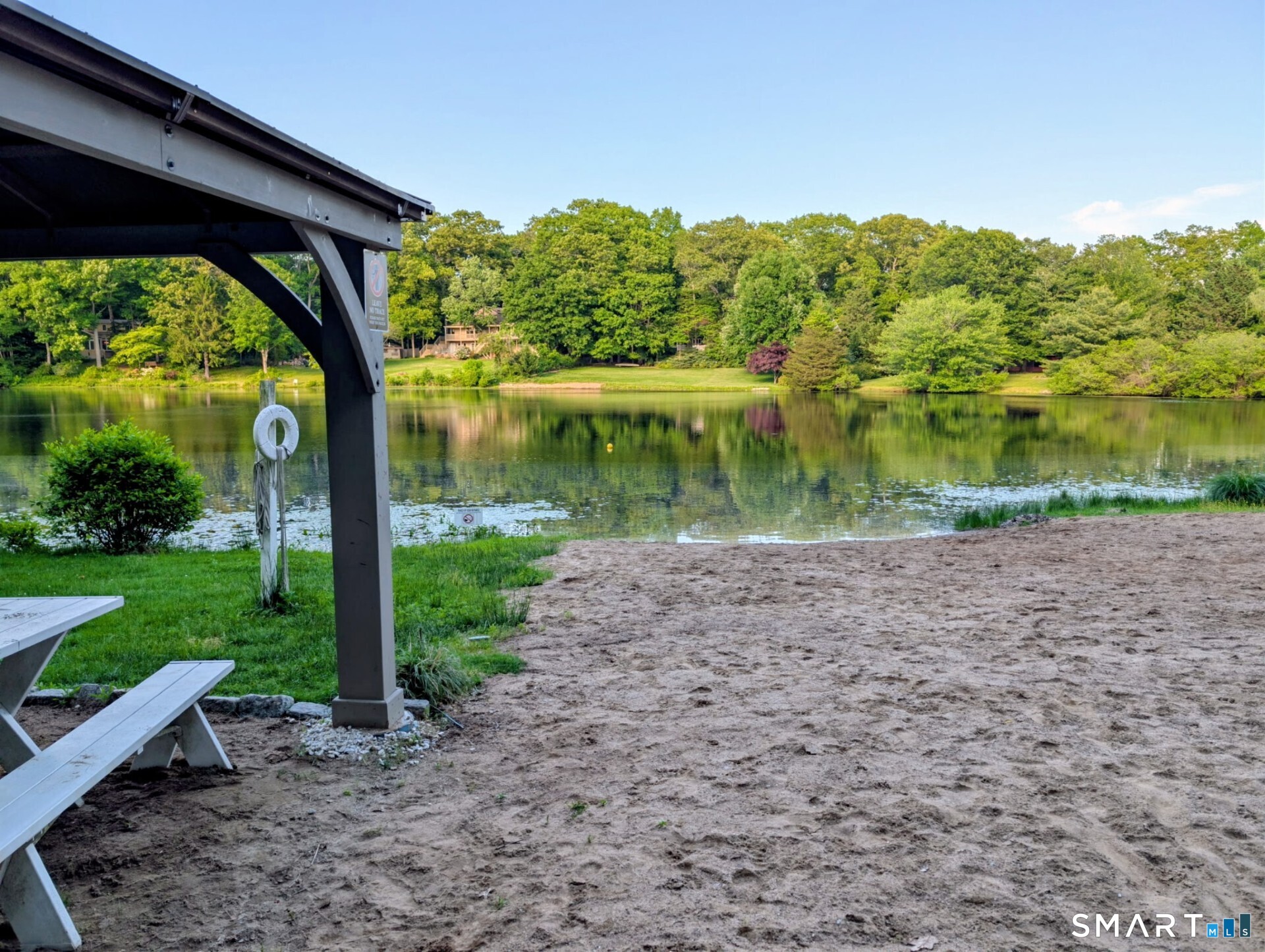 122 Ridgeview Circle Guilford, CT 06437 - Photo 38 of 40 Members enjoy the Association pond and beach which provides a safe, welcoming, and social atmosphere where neighbors can gather, relax, and mingle.