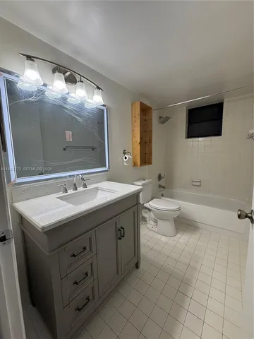 a bathroom with a double vanity sink and mirror