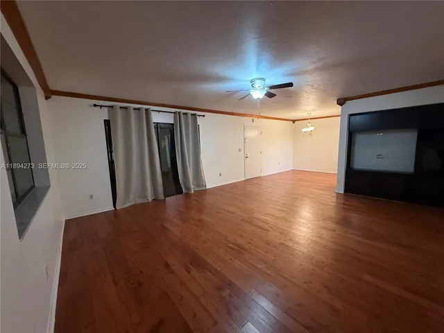 a view of hallway with stairs and wooden floor