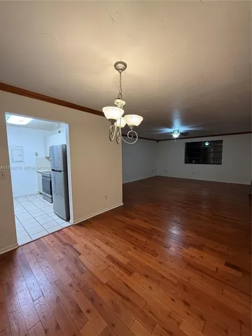 a view of a room with wooden floor