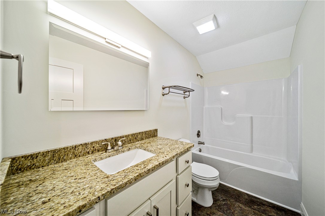 1745 Green Road Madison, OH 44057 - Photo 22 of 35 Full bathroom featuring tile floors, shower / washtub combination, large vanity, and toilet