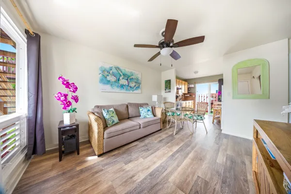 a living room with furniture and a wooden floor